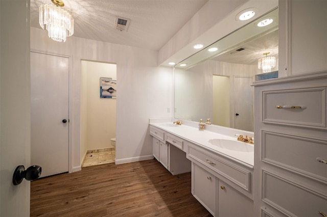 10730 Braes Bayou Dr, Houston, TX 77071 - full bath featuring a chandelier, double vanity, and wood finished floors