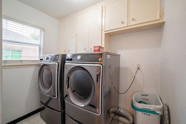 10730 Braes Bayou Dr, Houston, TX 77071 - washroom with cabinet space, washer and dryer, and light tile patterned floors