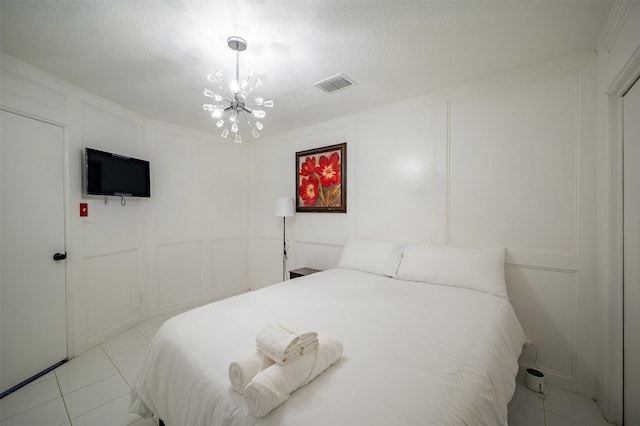 10730 Braes Bayou Dr, Houston, TX 77071 - bedroom featuring a decorative wall, a chandelier, and light tile patterned floors