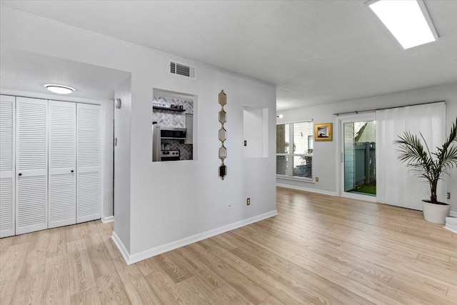 3220 69th St Unit E4, Galveston, TX 77551 - unfurnished living room featuring light wood-style floors