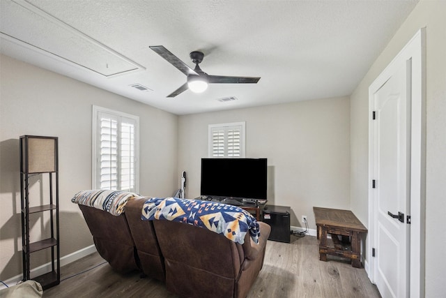 31730 Waller Tomball Rd, Waller, TX 77484 - living room with attic access, a ceiling fan, wood finished floors, and a textured ceiling