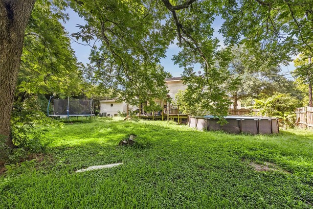 31730 Waller Tomball Rd, Waller, TX 77484 - view of yard featuring a trampoline and an outdoor pool