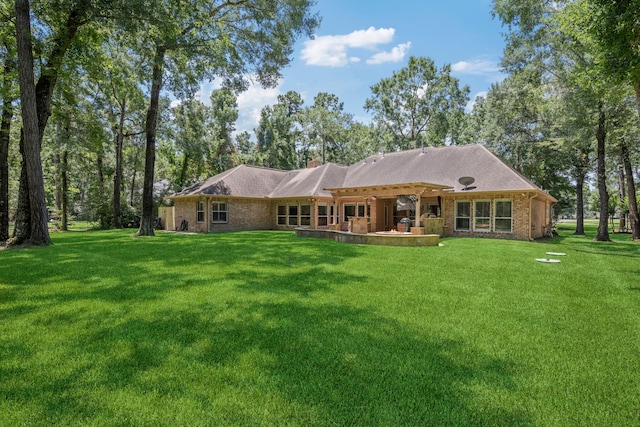 28322 Buena Way, Spring, TX 77386 - rear view of house featuring a yard, brick siding, and a patio