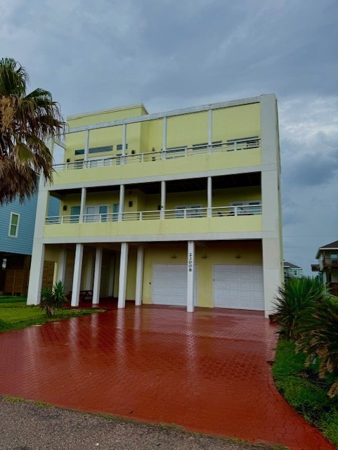 23008 Verano Dr, Galveston, TX 77554 - view of property featuring a garage and driveway