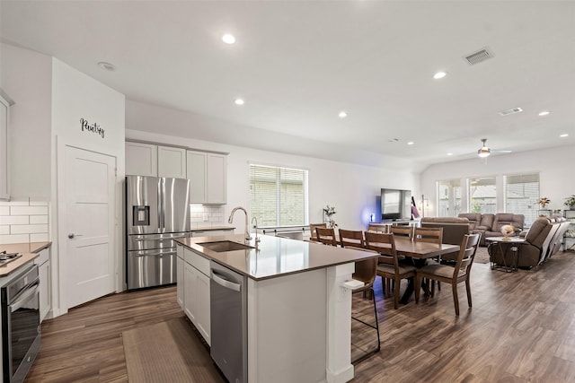 14320 Yellow Hawthorn Ct, Conroe, TX 77384 - kitchen featuring appliances with stainless steel finishes, dark wood-style flooring, tasteful backsplash, plenty of natural light, and recessed lighting