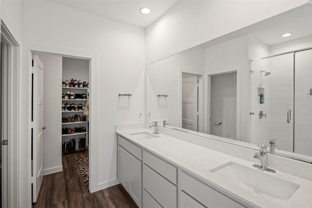 14320 Yellow Hawthorn Ct, Conroe, TX 77384 - full bath featuring a spacious closet, a stall shower, wood finished floors, double vanity, and recessed lighting