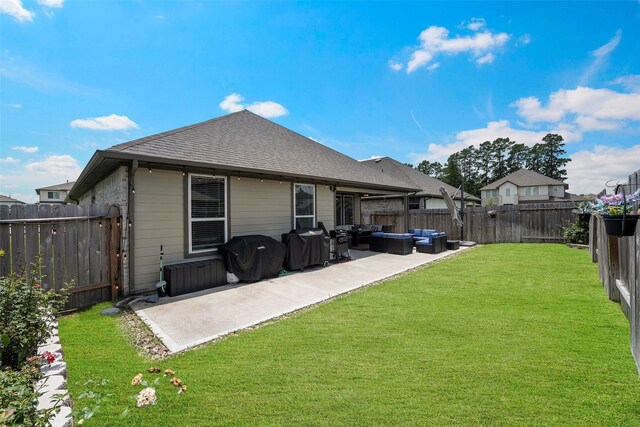 14320 Yellow Hawthorn Ct, Conroe, TX 77384 - back of property featuring an outdoor living space, a patio, a fenced backyard, and roof with shingles