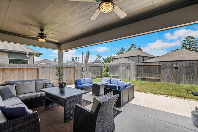 14320 Yellow Hawthorn Ct, Conroe, TX 77384 - fenced backyard with ceiling fan, outdoor lounge area, and a patio