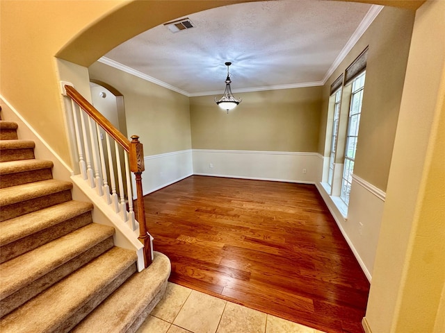 2716 W Oaks Cir E, Pearland, TX 77584 - staircase featuring arched walkways, ornamental molding, and tile patterned flooring
