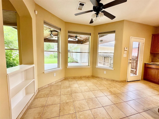 2716 W Oaks Cir E, Pearland, TX 77584 - unfurnished dining area featuring plenty of natural light, a ceiling fan, and light tile patterned flooring