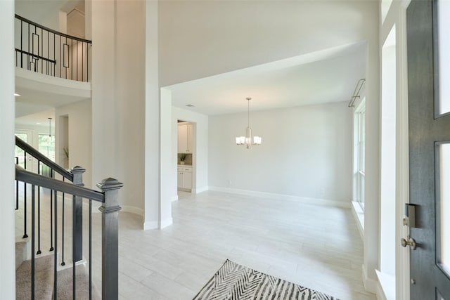 237 Patina Sorrel Dr, Montgomery, TX 77316 - entrance foyer with a chandelier, stairs, a towering ceiling, and light wood finished floors