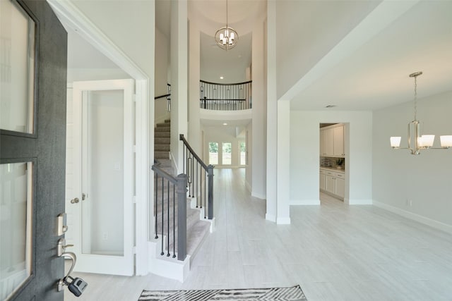 237 Patina Sorrel Dr, Montgomery, TX 77316 - entrance foyer featuring a chandelier, stairway, a high ceiling, and light wood finished floors