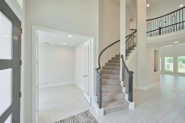 237 Patina Sorrel Dr, Montgomery, TX 77316 - stairway featuring a towering ceiling, wood finished floors, french doors, and recessed lighting