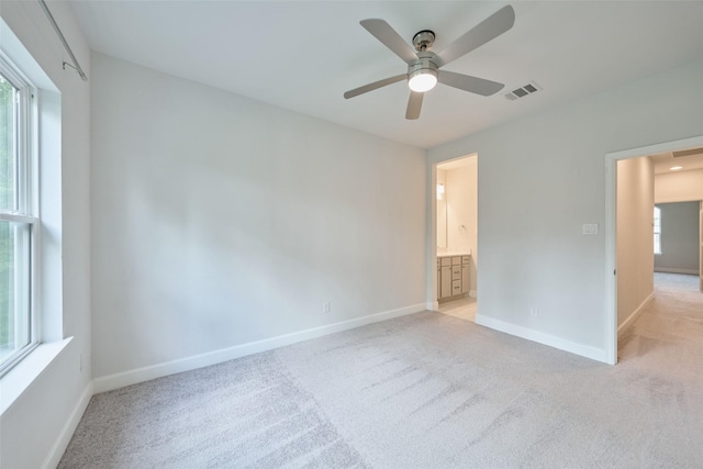 237 Patina Sorrel Dr, Montgomery, TX 77316 - unfurnished bedroom featuring light carpet, multiple windows, and connected bathroom