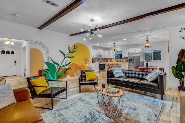 5918 Lattimer Dr, Houston, TX 77035 - living area featuring a chandelier, light wood-style flooring, beamed ceiling, a textured ceiling, and recessed lighting