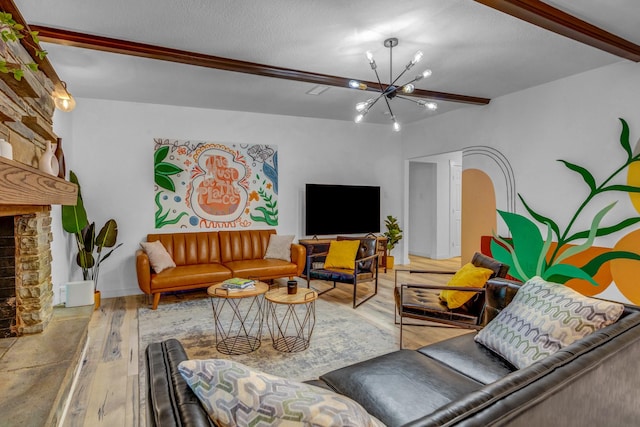 5918 Lattimer Dr, Houston, TX 77035 - living room featuring a chandelier, wood finished floors, beamed ceiling, and a stone fireplace