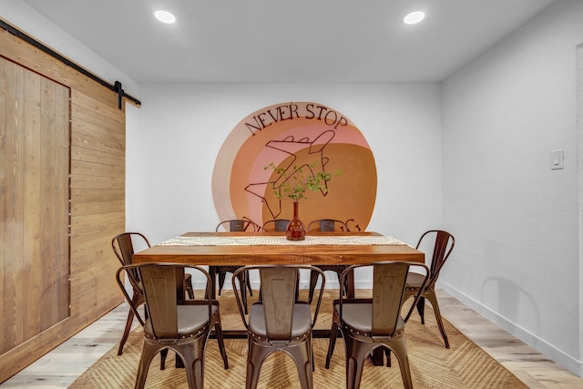 5918 Lattimer Dr, Houston, TX 77035 - dining space with a barn door, light wood finished floors, and recessed lighting