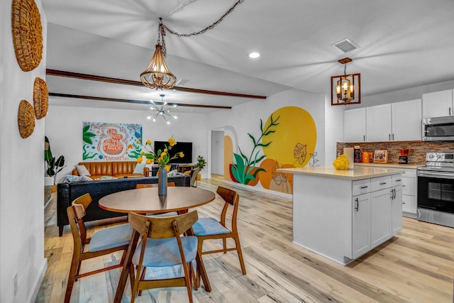5918 Lattimer Dr, Houston, TX 77035 - kitchen with a chandelier, appliances with stainless steel finishes, backsplash, white cabinets, and open floor plan