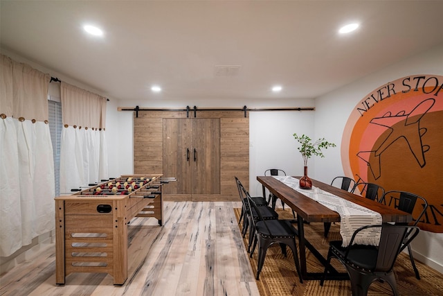 5918 Lattimer Dr, Houston, TX 77035 - dining room with a barn door, light wood finished floors, and recessed lighting