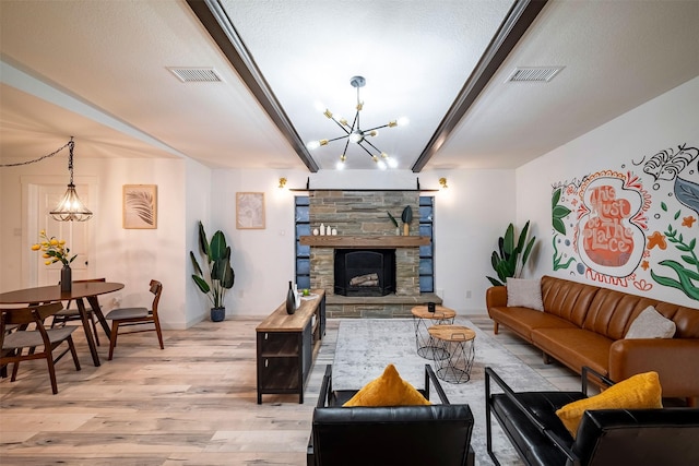 5918 Lattimer Dr, Houston, TX 77035 - living area with a chandelier, light wood finished floors, beam ceiling, and a stone fireplace