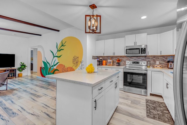 5918 Lattimer Dr, Houston, TX 77035 - kitchen featuring appliances with stainless steel finishes, light wood-type flooring, a chandelier, backsplash, and recessed lighting