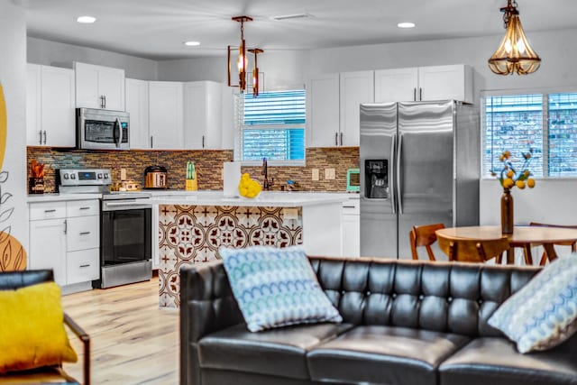 5918 Lattimer Dr, Houston, TX 77035 - kitchen with appliances with stainless steel finishes, plenty of natural light, white cabinetry, and recessed lighting