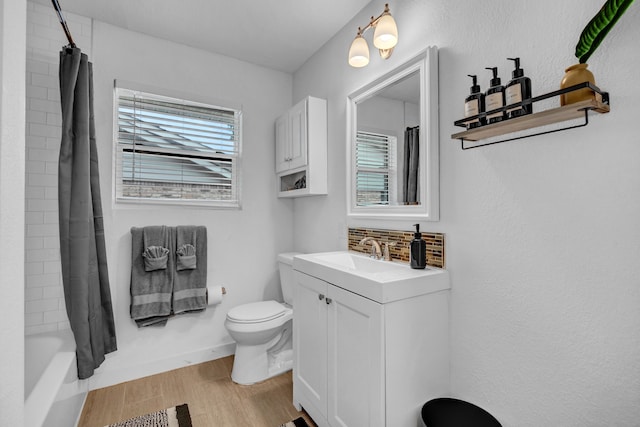 5918 Lattimer Dr, Houston, TX 77035 - full bathroom featuring wood finished floors, vanity, and shower / bath combo with shower curtain