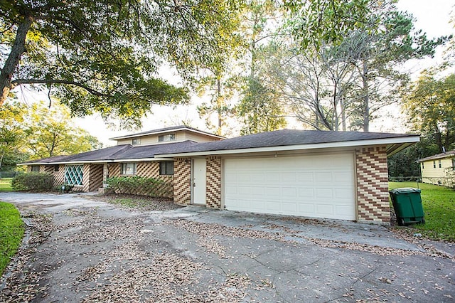 6407 Nuben St, Houston, TX 77091 - view of front of house with brick siding, asphalt driveway, and a garage