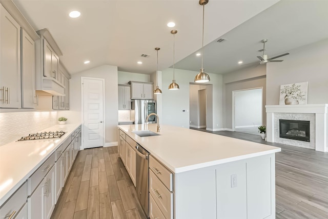20519 Grazing Foal Ln, Tomball, TX 77377 - kitchen featuring appliances with stainless steel finishes, light wood-style flooring, a ceiling fan, light countertops, and recessed lighting
