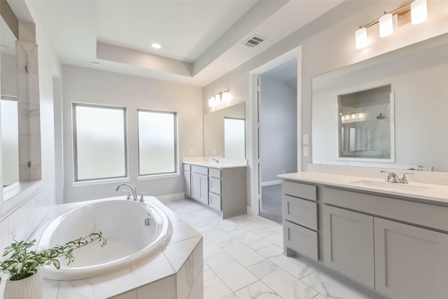 20519 Grazing Foal Ln, Tomball, TX 77377 - full bath featuring two vanities, a garden tub, marble look tiles, and recessed lighting