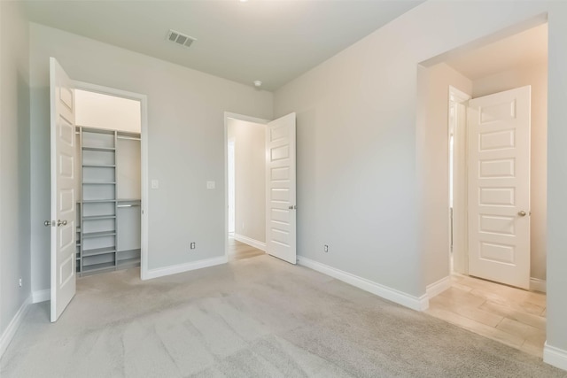 20519 Grazing Foal Ln, Tomball, TX 77377 - unfurnished bedroom with light carpet, a spacious closet, and a closet