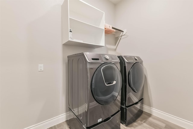 20519 Grazing Foal Ln, Tomball, TX 77377 - laundry area with separate washer and dryer and light wood-style flooring