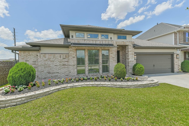 20519 Grazing Foal Ln, Tomball, TX 77377 - prairie-style home featuring an attached garage, concrete driveway, a front yard, and brick siding