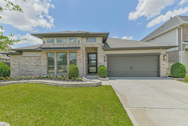 20519 Grazing Foal Ln, Tomball, TX 77377 - prairie-style home featuring a front yard, brick siding, a garage, and concrete driveway