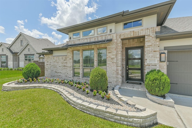 20519 Grazing Foal Ln, Tomball, TX 77377 - view of front of home featuring brick siding, a front yard, an attached garage, and roof with shingles