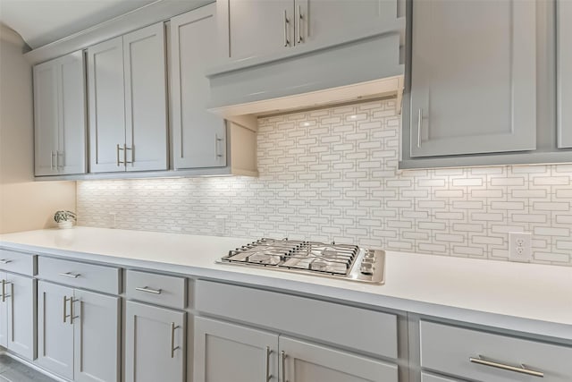20519 Grazing Foal Ln, Tomball, TX 77377 - kitchen featuring gray cabinetry, under cabinet range hood, light countertops, and stainless steel gas cooktop