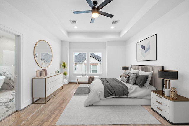 1011 E 28th St, Houston, TX 77009 - bedroom with a tray ceiling, light wood-type flooring, recessed lighting, and ceiling fan