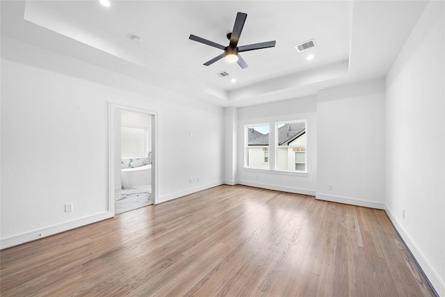 1011 E 28th St, Houston, TX 77009 - spare room with a tray ceiling, wood finished floors, ceiling fan, and recessed lighting