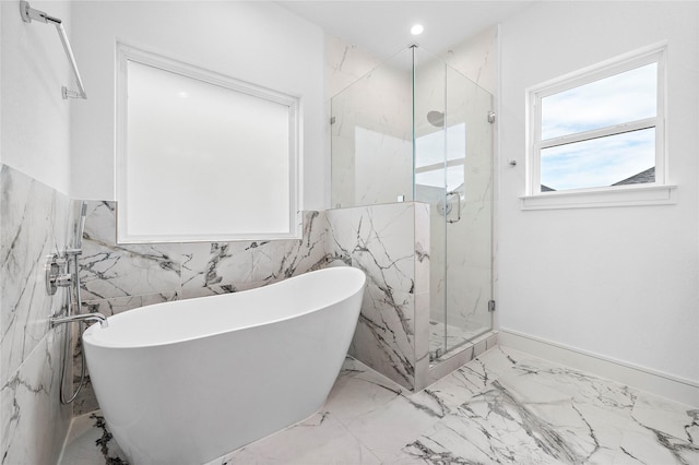 1011 E 28th St, Houston, TX 77009 - full bathroom featuring tile walls, a marble finish shower, a freestanding bath, marble tiled flooring, and a wainscoted wall