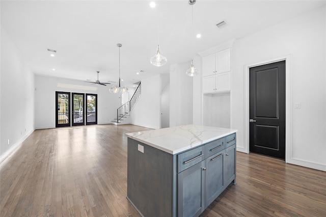 1011 E 28th St, Houston, TX 77009 - kitchen with white cabinetry, wood finished floors, a kitchen island, pendant lighting, and recessed lighting