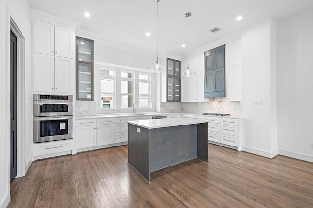 1011 E 28th St, Houston, TX 77009 - kitchen with double oven, dark wood-style floors, backsplash, stovetop, and glass insert cabinets