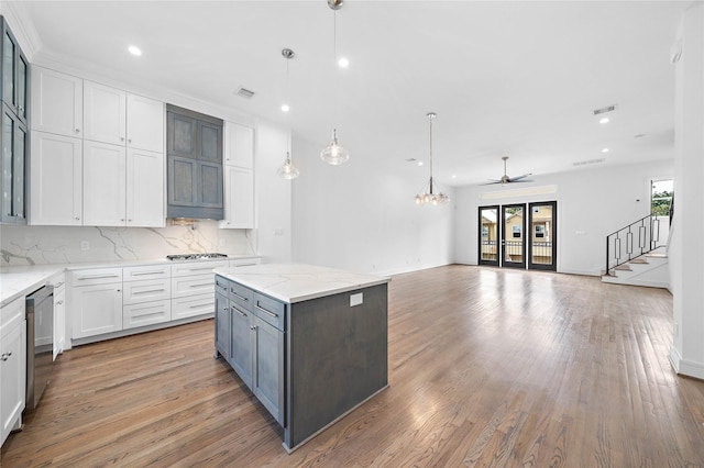 1011 E 28th St, Houston, TX 77009 - kitchen featuring cooktop, recessed lighting, light wood-type flooring, open floor plan, and white cabinetry