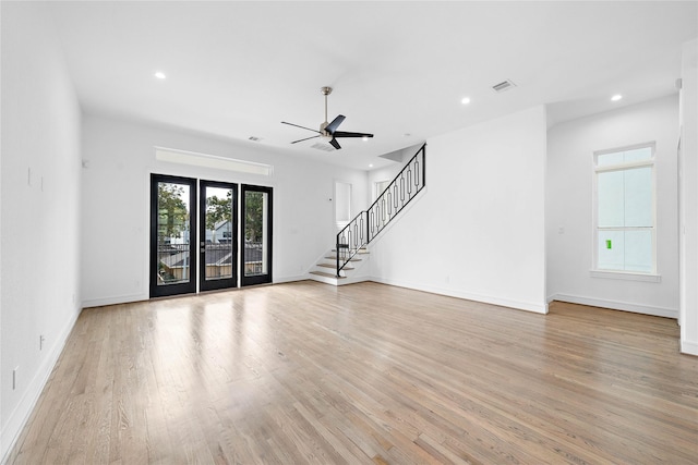 1011 E 28th St, Houston, TX 77009 - unfurnished living room featuring light wood-style flooring, stairs, a ceiling fan, and recessed lighting