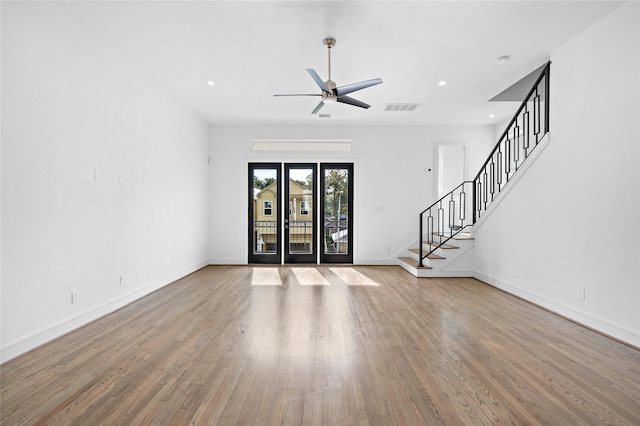 1011 E 28th St, Houston, TX 77009 - unfurnished living room with wood finished floors, stairway, ceiling fan, and recessed lighting