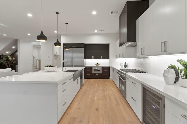 4332 Lafayette St, Bellaire, TX 77401 - kitchen with wine cooler, modern cabinets, high end appliances, a large island with sink, and recessed lighting