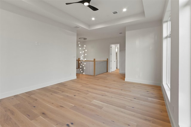 4332 Lafayette St, Bellaire, TX 77401 - empty room with a ceiling fan, light wood finished floors, a tray ceiling, and recessed lighting