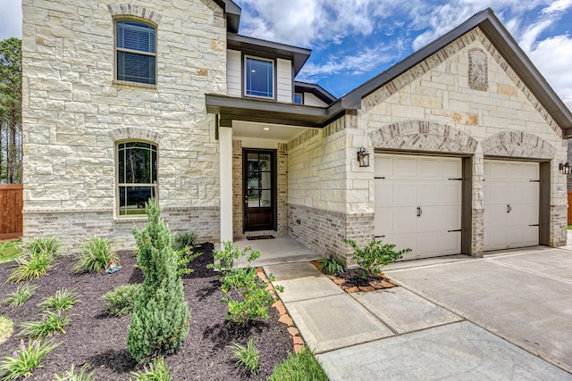 1563 Rd 66114, Dayton, TX 77535 - french country inspired facade featuring stone siding, a garage, and concrete driveway
