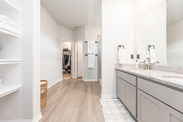 1563 Rd 66114, Dayton, TX 77535 - full bathroom with a stall shower, wood finished floors, double vanity, and a spacious closet