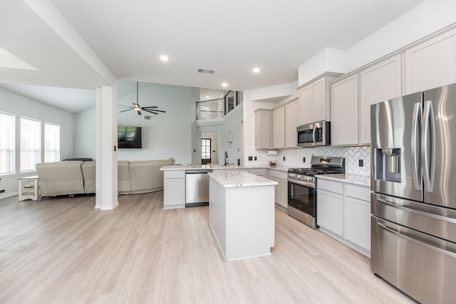 1563 Rd 66114, Dayton, TX 77535 - kitchen with appliances with stainless steel finishes, open floor plan, ceiling fan, plenty of natural light, and recessed lighting