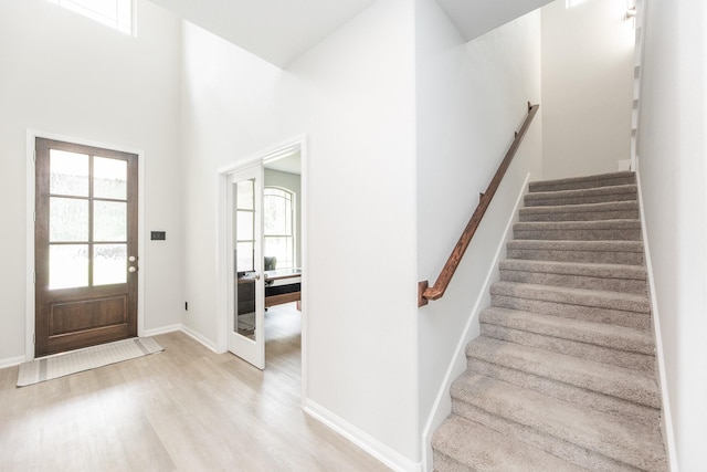 1563 Rd 66114, Dayton, TX 77535 - foyer with plenty of natural light, light wood-style flooring, stairs, and a high ceiling